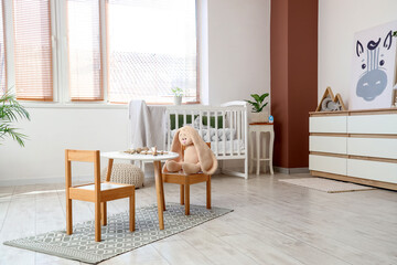 Interior of nursery with crib and tables