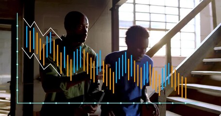 Mentor guiding apprentice starting descending staircase in woodworking shop, moving toward lumber - Powered by Adobe