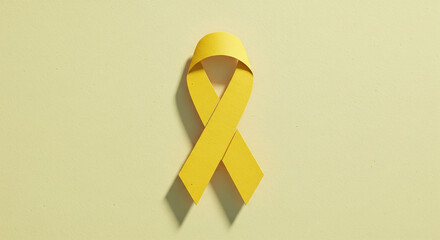 Paper cutout yellow ribbon design for mental health awareness campaign materials