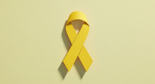 Paper cutout yellow ribbon design for mental health awareness campaign materials