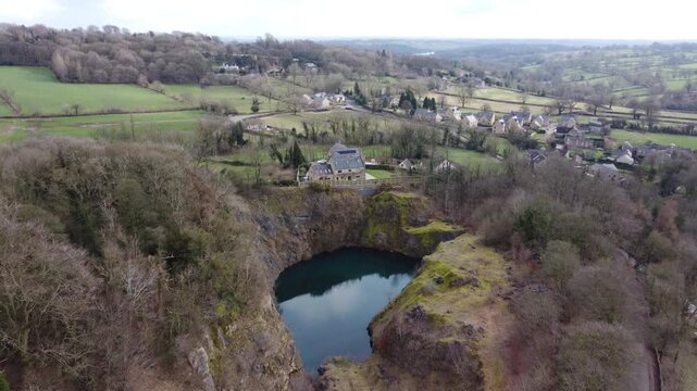 Ashover, North East Derbyshire, England - February 25 2024: Aerial drone footage captures the scenic countryside landscape of Ashover, featuring rolling hills, scattered houses, and green fields.