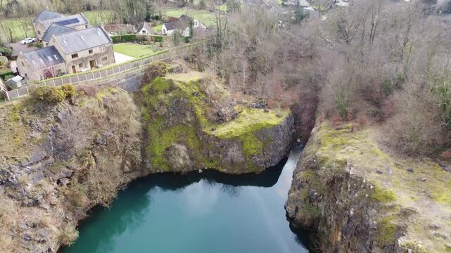 Ashover, North East Derbyshire, England - February 25 2024: Drone footage captures the scenic beauty of Fall Hill Quarry and the surrounding countryside.