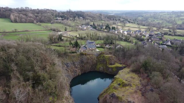 Ashover, North East Derbyshire, England - February 25 2024: Drone footage captures a scenic view of Fall Hill Quarry lake.