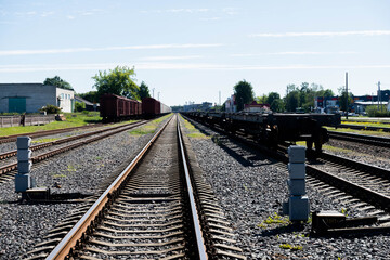 Fototapeta premium Shiny metal railway tracks stretching far into the distance