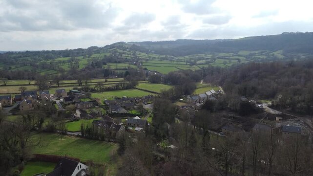 Ashover, North East Derbyshire, England - February 25 2024: Scenic drone footage captures the tranquil blue waters of Fall Hill Quarry lake.