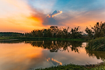 Paisagem ao entardecer com reflexo na água