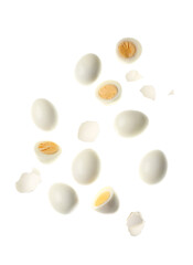 Flying boiled chicken eggs with shells on white background