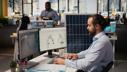 Engineer in office working on solar panel CAD design to develop technology improving environmental...
