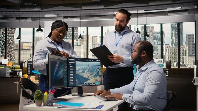 Team of engineers in office doing green energy production technology testing. Teamworking colleagues research cutting edge solutions for biodiversity conservation in renewable energy sector, camera A