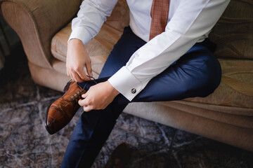 Man tying his rows of shoes