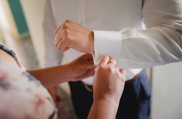 Fixing the groom's cufflinks