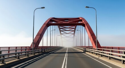 Red arch bridge with street lamps over foggy road on clear day