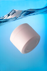 Pink cosmetic jar underwater