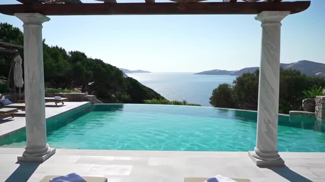 Infinity pool overlooking the ocean framed by columns and lounge chairs on deck area