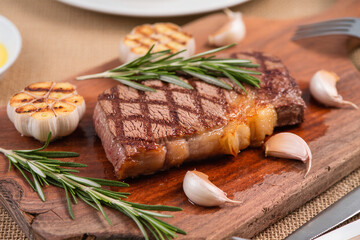 Grilled Beef Steak with Herbs on Wooden Board