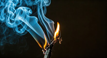 Burning stick, blue smoke, dark background