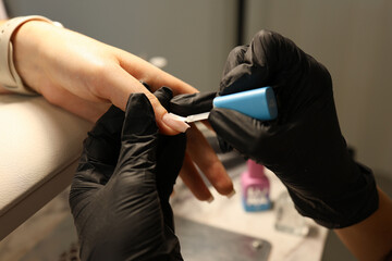 Receiving Professional Manicure in Modern Salon