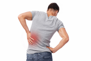 Millennial european man suffer from muscle pain, pressing hand to back, isolated on white...