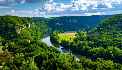 A tranquil river meanders through a verdant valley, framed by lush forests and rolling hills under a partly cloudy sky.