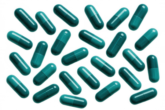 Teal green pharmaceutical capsules scattered across transparent surface, representing medical healthcare design element