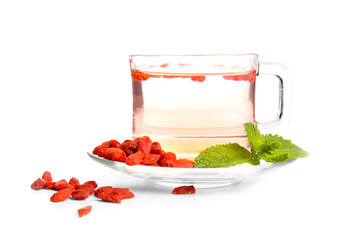 Glass cup of hot goji tea with mint and berries on white background