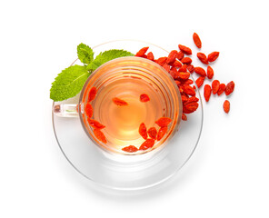 Glass cup of hot goji tea with mint and berries on white background