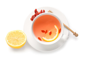 Cup of hot goji tea with lemon and berries on white background