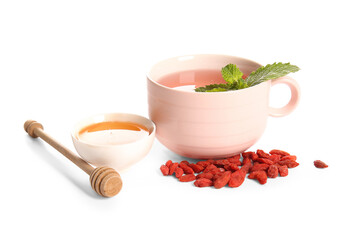 Cup of hot goji tea with mint and bowl of honey on white background