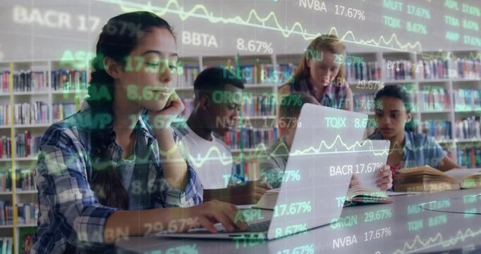 Standing girl pointing at laptop causing library students analyzing financial data for research