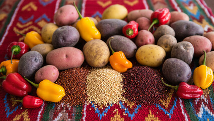 The display includes various types of potatoes (including purple and red), vibrant peppers, and three distinct piles of quinoa (red, white, and black).