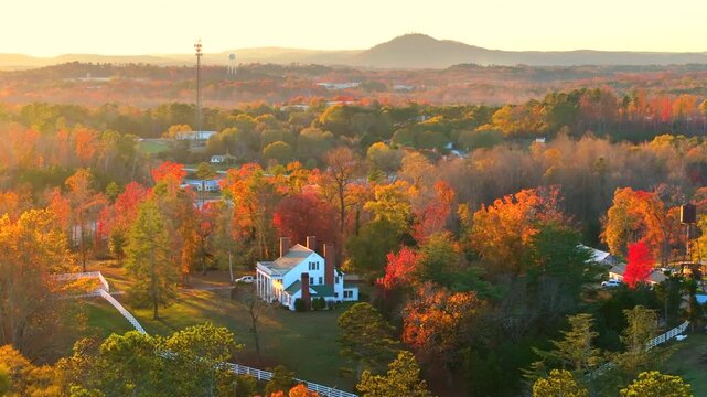 Rural homes and mansions on wooded slopes of Tennessee in colorful fall season. Scenic autumn view of Appalachian forest hills.