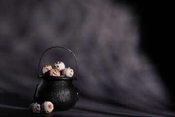 Pumpkins in black pot, Halloween concept