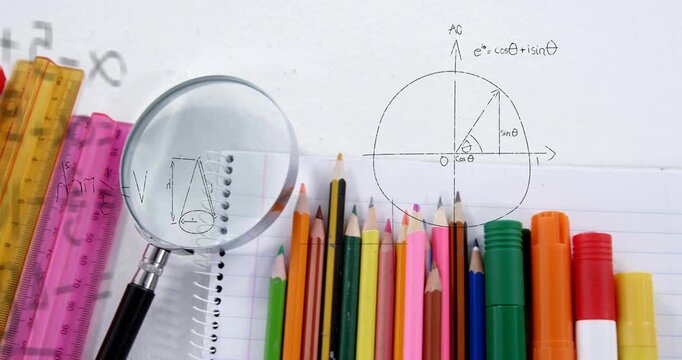 Camera panning right as magnifying glass slides over pencils and notebook, revealing math diagrams