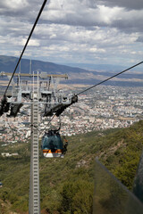 Aerial view from a cable car showing the sprawling city of Skopje, North Macedonia, nestled in a...