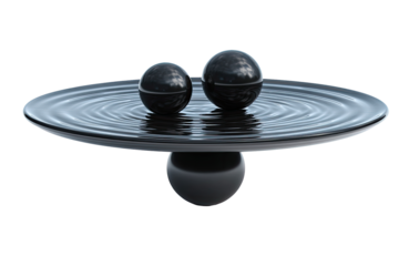 Two black spheres rest on a dark liquid surface, creating ripples on a flat, dark plate.  A mirrored reflection beneath