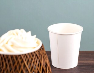 Empty disposable coffee cup, frothy cream, wicker basket