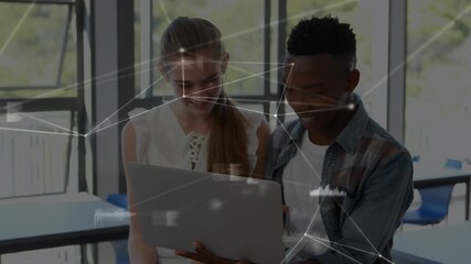 Female and male students tapping keyboard activating network overlay on laptop in education lab - Powered by Adobe