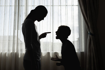 parent firmly correcting their upset child near a window, symbolizing discipline, guidance, family...