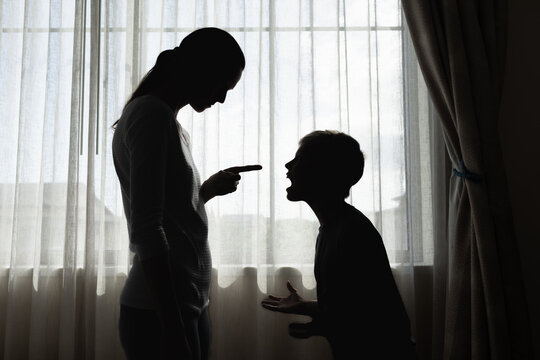 parent firmly correcting their upset child near a window, symbolizing discipline, guidance, family interactions, responsibilities, and developmental life lessons between family members in a household 
