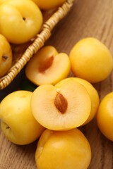 Ripe yellow cherry plums on wooden board, closeup