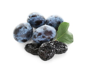 Dried prunes, fresh plums and green leaf isolated on white, above view