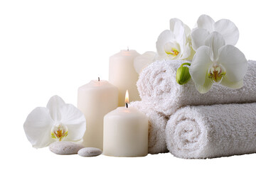 White candles, orchids, and towels in a spa setting