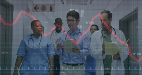 Walking medical team analyzing patient data in hospital corridor, with clipboards red graph