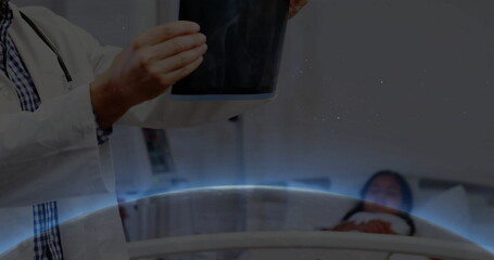 Holding chest X-ray film with stethoscope, doctor examining child patient in hospital, copy space