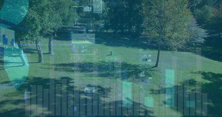 Projecting translucent bar charts line graphs and globe icons over park lawn, with wooden benches