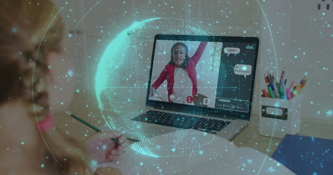 Writing girl using green pencil in notebook at home study desk, laptop, colored pencils, copy space