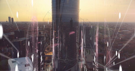 Reflecting cylindrical glass skyscraper glowing at sunset on downtown skyline, with network overlay
