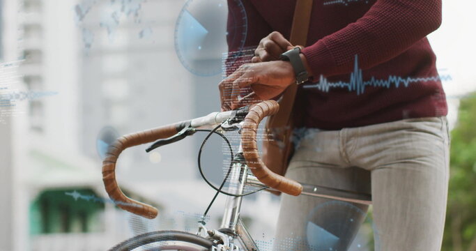 Cyclist gripping bike bars and adjusting smartwatch on sidewalk with maroon sweater and strap bag