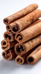 Stacked Cinnamon Sticks On White Background