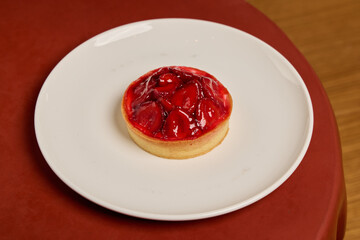 An incredibly delicious Strawberry Tart meticulously placed on a pristine white plate